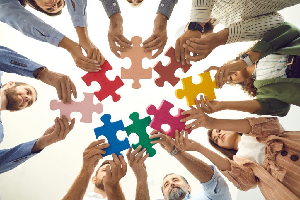 Creative,Business,Team,Trying,To,Fit,Colorful,Jigsaw,Puzzle,Pieces