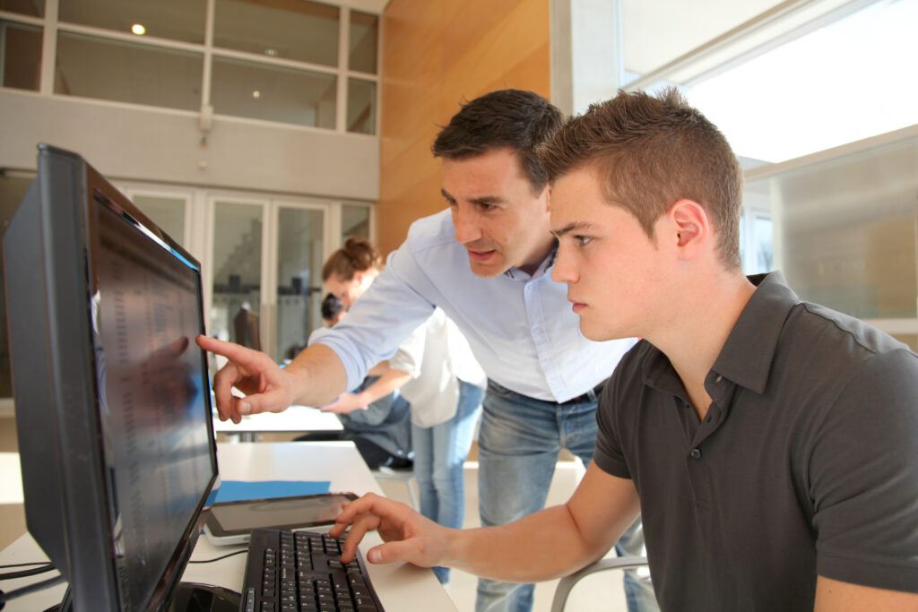 Teacher,And,Student,Working,On,Computer