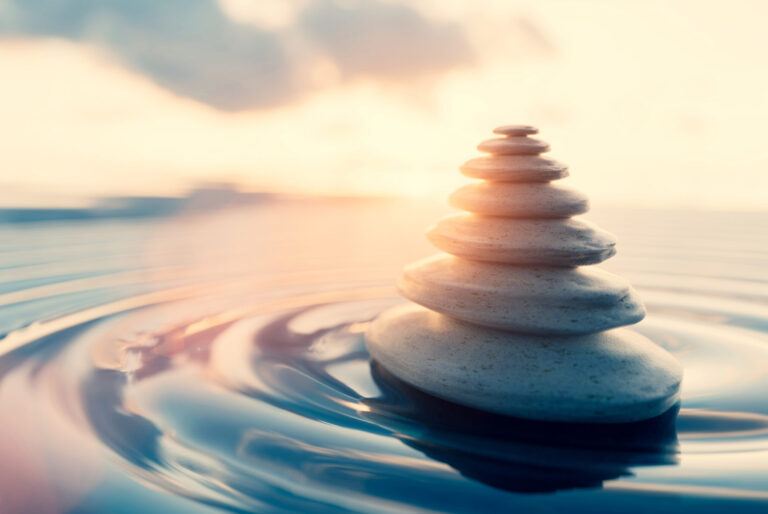 Mindfulness and meditation background. Zen rocks on water at sunset. 3D render
